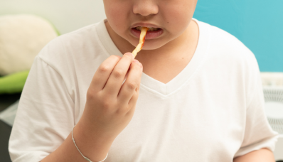 An overweight teenager eating French fries.   ©Getty Images 